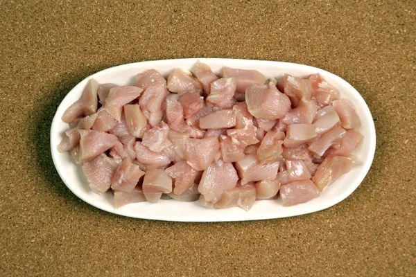 Raw chicken meat in the plate on the table Royalty Free Stock Images