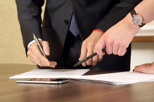 Hands of business men and women studying the documents — Stock Photo, Image