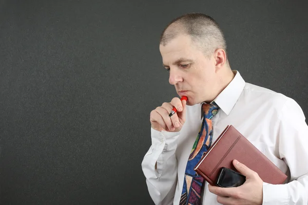 Hombre de negocios con camisa blanca con bolígrafo, cuaderno y teléfono móvil —  Fotos de Stock