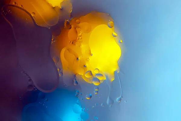 colored drops of oil liquid on glass. abstraction background texture