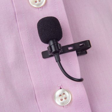 Klipsli mikrofon kadın kıyafetlerine yakın planda takılır. Yoğunlaştırıcı mikrofondaki sesin ses kaydı.