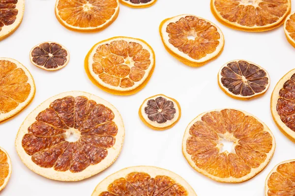 mix of different pieces of dried citrus fruit on white background