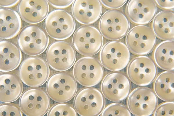 Plastic shiny buttons for clothes. Fashion and clothing. Factory industry.