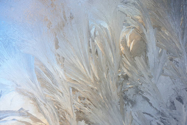 frosty patterns on the window glass closeup. natural textures and backgrounds. ice patterns on frozen