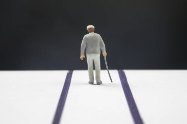Minyatür insanlar. Sopalı yaşlı bir emekli ömrünün sonuna kadar yolda yürür. Yalnızlık ve depresyon