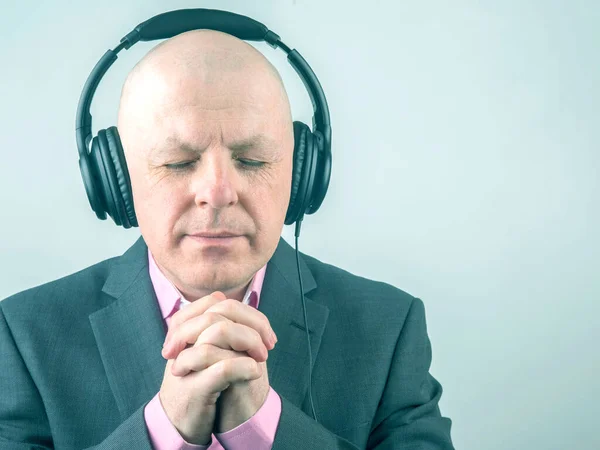 portrait of a business man with headphones in relaxation listening to his favorite music