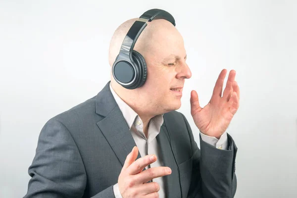 portrait of a business man with headphones in relaxation listening to his favorite music