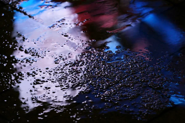 Reflection in a puddle after rain advertising — Stock Photo, Image