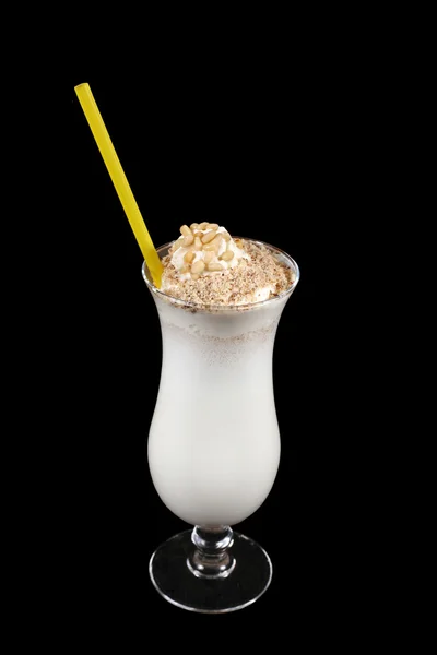 Milk shake with nuts on black background — Stock Photo, Image