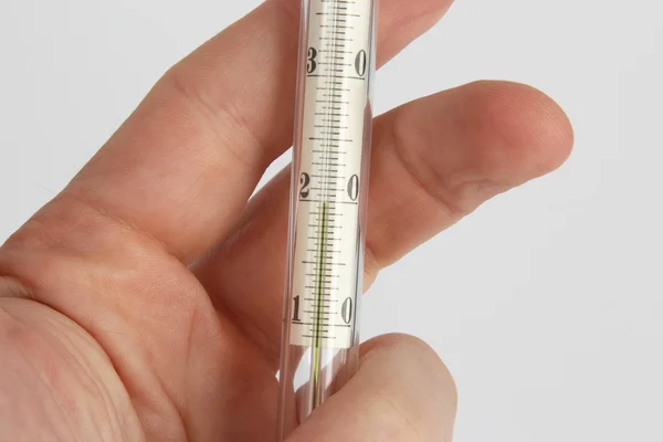 Thermometer in hand closeup — Stock Photo, Image