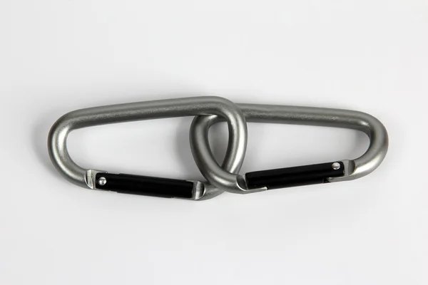 Two united climbing carabiner on a white background — Stock Photo, Image