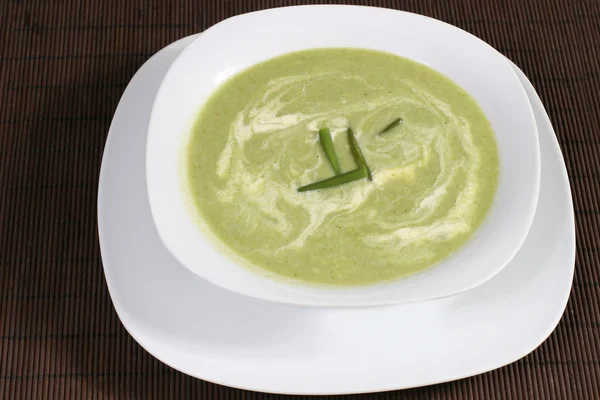 Pea soup with greens and sour cream Stock Picture