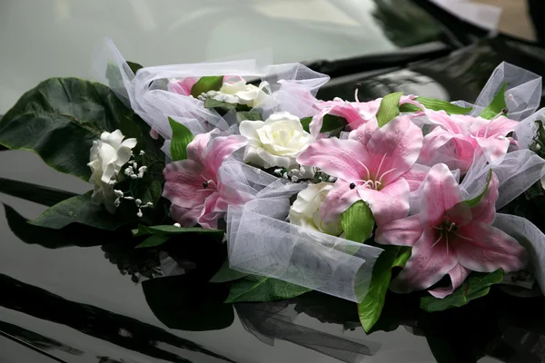 Beautiful bouquet of ornamental flowers on the hood of the car — Stock Photo, Image