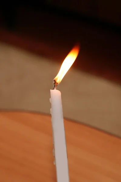 One white burning candle — Stock Photo, Image