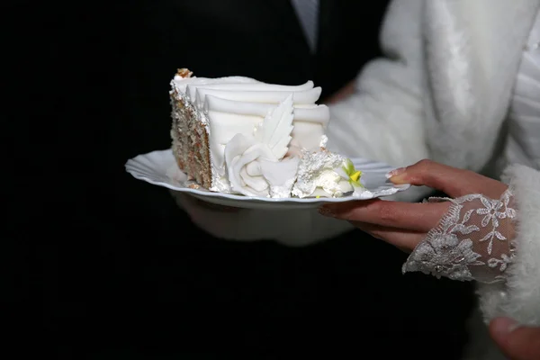 Cortar un pedazo de pastel de boda en las manos de la novia —  Fotos de Stock