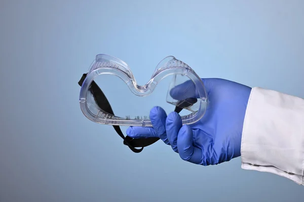 Doctor Hand Gives Eye Protective Plastic Glass Mask