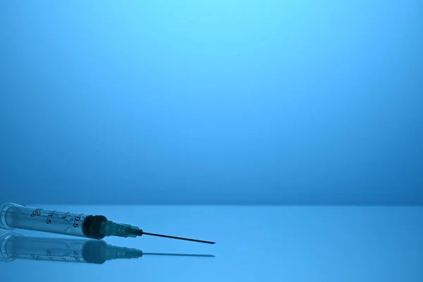 Inoculation Syringe on Blue Gradient Background with Copyspace