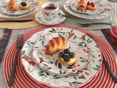 Table setting with bright tableware, berries, and twigs. Dessert on plate. Aesthetics and lifestyle. Home design. . High quality photo