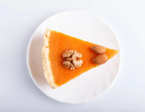 A slice of traditional american sweet pumpkin pie isolated on white background. top view.