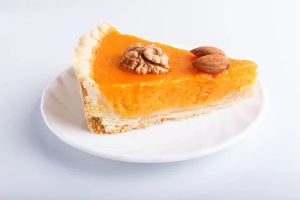 A slice of traditional american sweet pumpkin pie isolated on white background. close up.