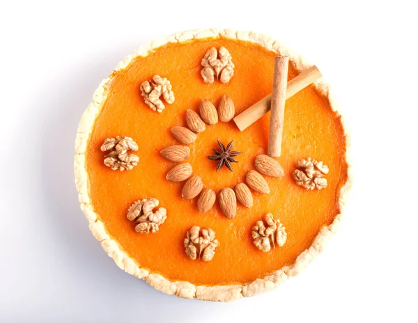 Traditional american sweet pumpkin pie decorated with nuts, isolated on white background. top view.