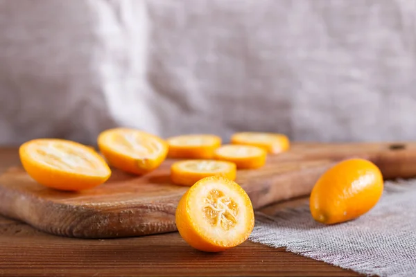 Sliced Kumquats Wooden Kitchen Board Close Selective Focus Copy Space — Stock Photo, Image
