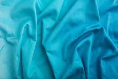 Pamuk mavisi bir doku parçası. Üst görünüm, doğal tekstil arka plan ve doku. dalga konsepti, soyut.