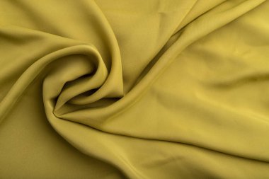 Yeşil zeytin ipeği dokusu. Üst manzara, düz döşeme, doğal tekstil arka plan ve doku. dalga konsepti, soyut, sarmal biçim.