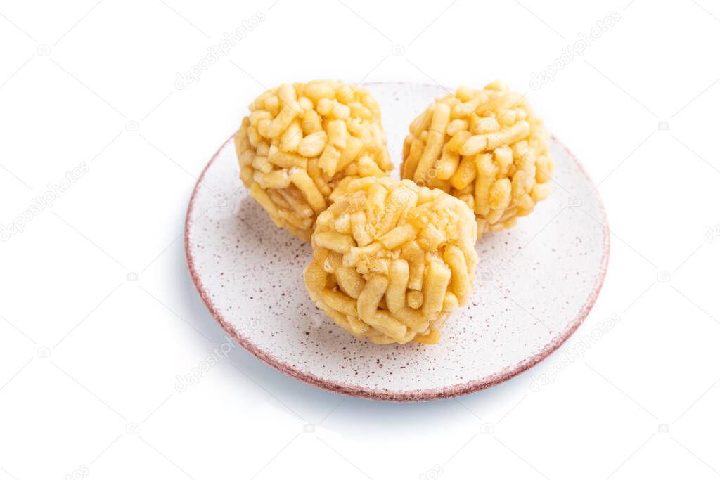 Traditional Tatar candy chak-chak made of dough and honey isolated on white background. Side view, close up.
