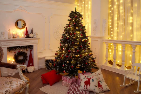 Interior de Ano Novo com árvore de Natal, lareira, travesseiros. Foto da noite muito bonita para o Natal — Fotografia de Stock