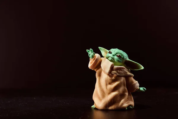 March, 2021: Display of Baby Yoda, an action figures. Stands on black backgroun. High quality photo