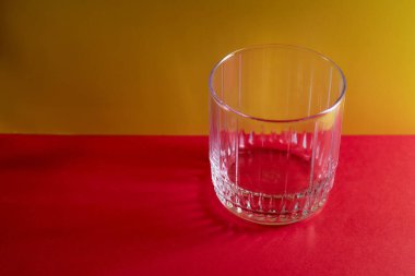 Glass glass on a yellow and red background. With copy space.