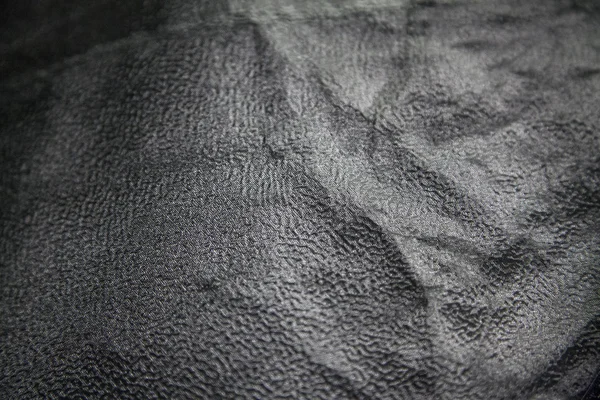 Crumpled black fabric plastic texture — Stock Photo, Image