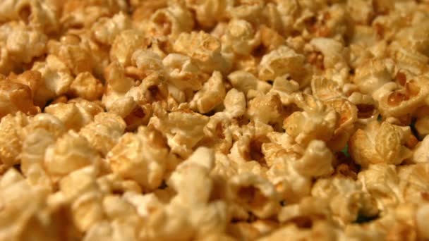 Popcorn on a green background. Slow motion. Close-up. Horizontal and vertical pan. 3 Shots — Stock Video