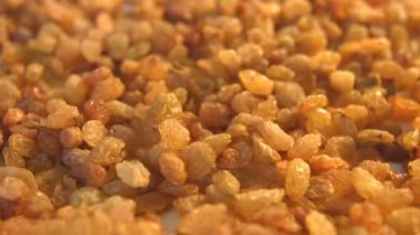 Beyaz zemin üzerine kuru üzüm. 2 Shots.Vertical pan. Yakın çekim.