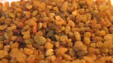 Bej (doku tablo, yüzey) arka plan üzerinde kuru üzüm. 2 Shots.Vertical pan. Yakın çekim.