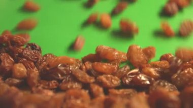 Yeşil bir arka plan üzerine kuru üzüm. 2 tekila. Dikey pan. Yakın çekim.