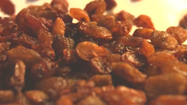 Raisins on a white background. 2 Shots.Vertical pan. Close-up. — Stock Video