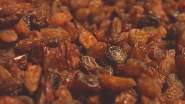 Raisins on a beige (texture table surface) background. 2 Shots. Slow motion. Horizontal pan. Close-up. — Stock Video