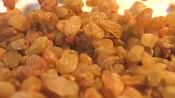Raisins on a beige (texture table surface) background. 2 Shots. Slow motion Horizontal pan. Close-up. — Stock Video