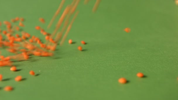 Lentils on a green background. Slow motion. Close-up. Vertical pan. 2 Shots — Stock Video