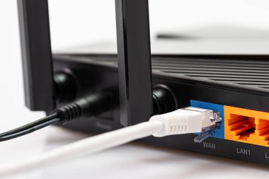 Kablosuz internet yönlendiricisi bağlı kablolar fiber optik internetin arkası ve bir yönlendiriciye bağlı ağ kabloları. İnternet güvenliği ve yüksek hızlı konsept. Seçici odak... yakın plan.