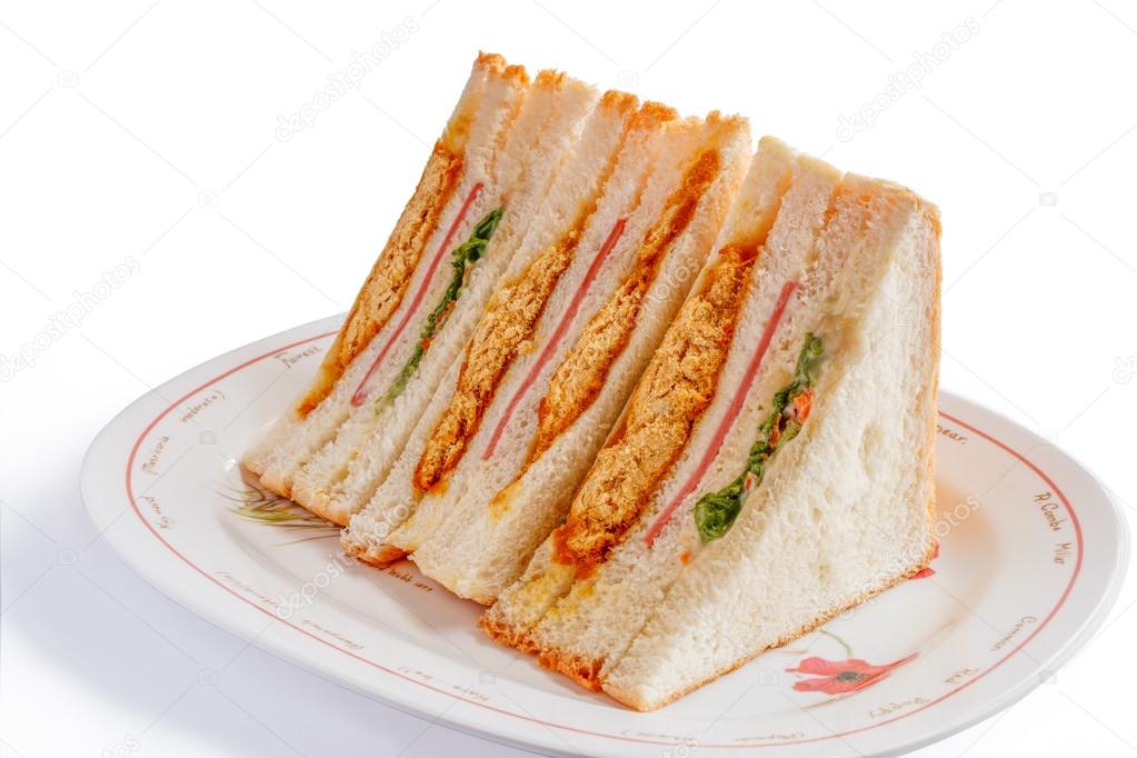 Sandwiches in front of a platter of various fillings