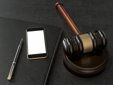 Wooden judges gavel and phone on black leather desk