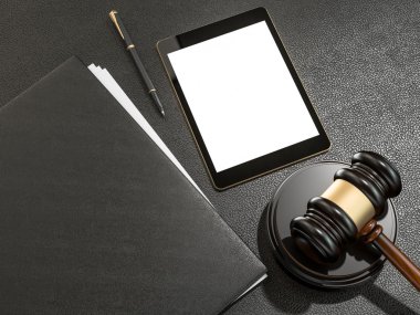 Wooden judges gavel and tablet computer on black leather desk