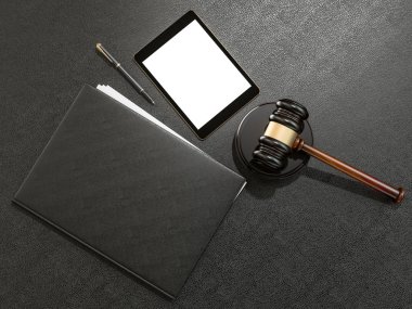 Wooden judges gavel and tablet computer on black leather desk