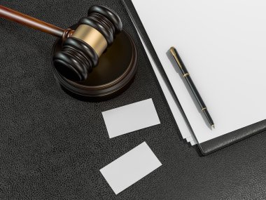Wooden judges gavel, business cards on black leather desk