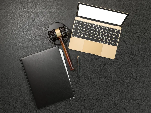 Wooden judges gavel and laptop computer on black leather desk — Stockfoto