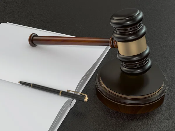 Wooden judges gavel and open book on black leather desk — Stockfoto