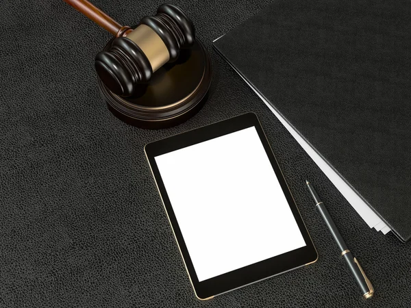 Wooden judges gavel and tablet computer on black leather desk — Stockfoto